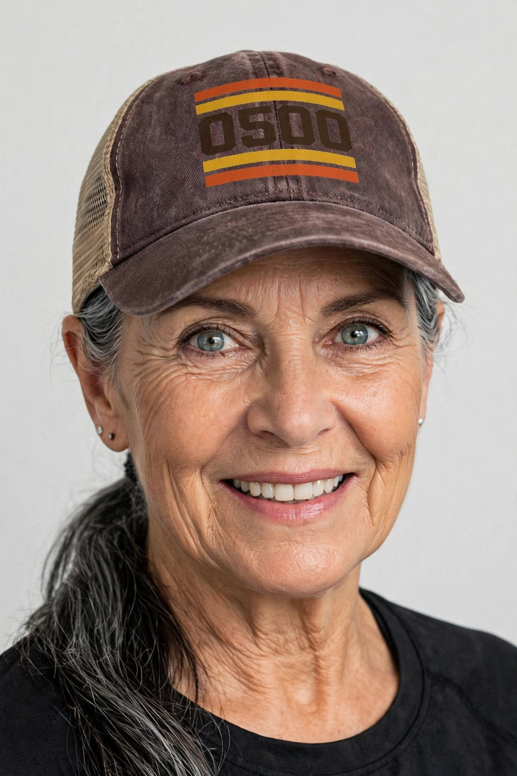 Woman wearing the 0500DISCIPLINE Women’s Washed Mesh-Back Cap — RETRO Edition in Chocolate / Fawn / Khaki