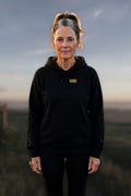 0500DISCIPLINE — Women's Earn the Sunrise Hoodie lead photo on real stock background (2026-10-22)